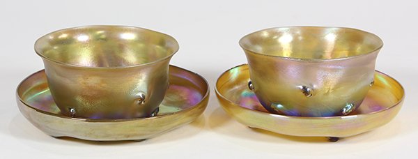 (lot of 2) Tiffany Studios New York gold favrile finger: (lot of 2) Tiffany Studios New York gold favrile finger bowls with underplates, each decorated with pigtail prunts, each signed "L.C.T." and numbered respectively "N6364", "N6398", "N6378", "N6403", 2