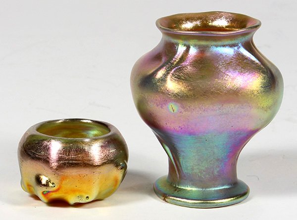 (lot of 2) Tiffany Studios gold favrile vase, having a: (lot of 2) Tiffany Studios gold favrile vase, having a tapered urn form, signed "L.C.T., M6565" and bearing original favrile label, 3"h; together with a salt cellar, having a pinched base, signed "L.C