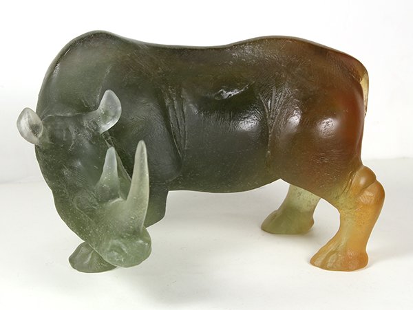 Daum France Grand Rhinoceros: Daum France Grand Rhinoceros, executed in grey and amber pate de verre, his head turned to the side displaying two horns, signed to the front right leg, with original box, 6"h x 9"w x 7"d