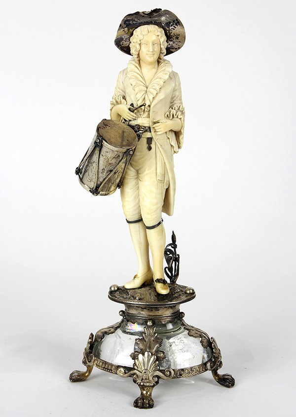 German silver-mounted ivory and rock crystal table: German silver-mounted ivory and rock crystal table ornament in the Rococo taste, 19th century, depicting a drummer wearing a silver hat and carrying a silver drum, resting on an oval silver base above