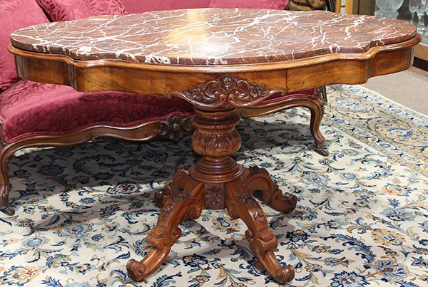 American Rococo Revival turtle top center table,: American Rococo Revival turtle top center table, executed in rosewood, having a rouge marble inset top above the conforming apron with a single drawer, and rising on an urn form standard with four flo