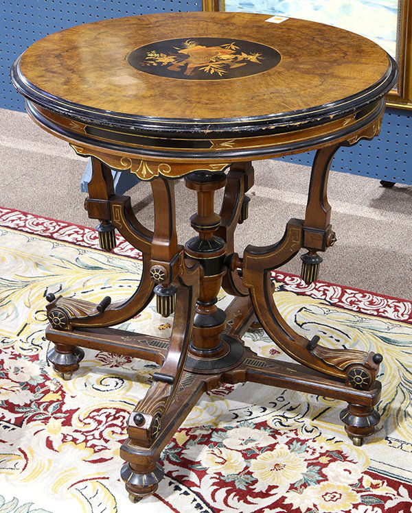 American Renaissance Revival walnut: American Renaissance Revival walnut, ebonized, incised and marquetry decorated center table, by Berkey and Gay, circa 1870, the top with a musical trophee reserve, having a banded edge, surmounting a