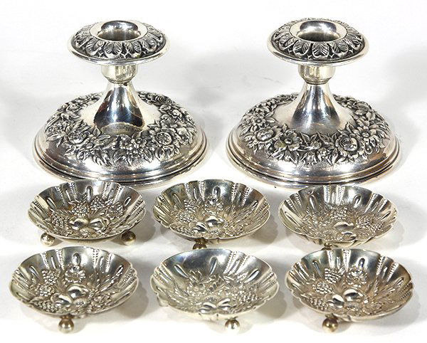 S.Kirk & Son sterling silver repousse table: (lot of 9) S.Kirk & Son sterling silver table accessories consisting of a pair floral repousse deocorated low candle holders with weighted bases; together with six footed nut dishes decorated with rep