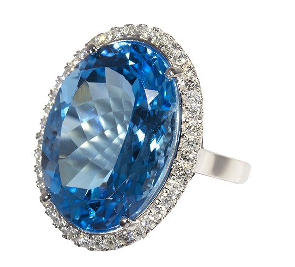 Large blue topaz, diamond and 14k white gold ring: Large blue topaz, diamond and 14k white gold ring featuring (1) large oval blue topaz measuring approximately 24.2 X 17.5 mm, weighing approximately 38.04 cts., accented by full cut diamonds weighing