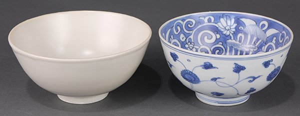 Two Chinese Porcelain Bowls: (lo of 2) Chinese porcelain bowls, Ming dynasty, one with a deep body and overall coated with a milky white glaze; together with a blue-and-white bowl, the interior side with a lotus pond reserved on 