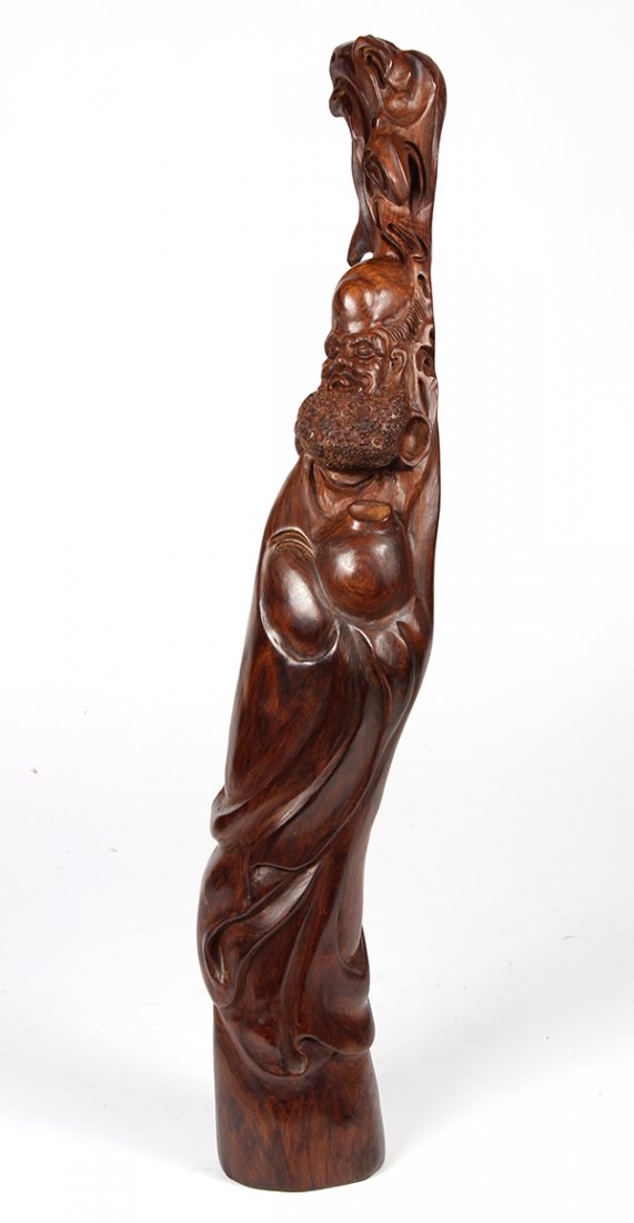 Chinese Wooden Damo: Chinese carving of Buddhist figure, possibly huanghuali, the gnarled segment of wood shaped as Damo holding a jar, 20"h