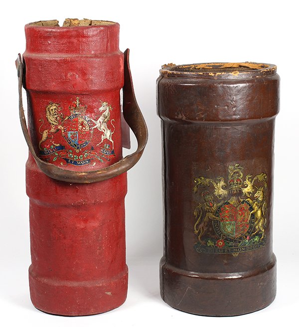 (lot of 2) English fire buckets: (lot of 2) English fire buckets, now used as umbrella stands, the first executed in brown leather, the second executed in canvas and painted red, each centers a heraldic family crest, tallest 21"h x 7