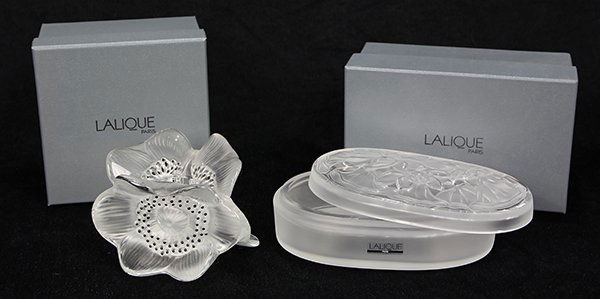 (lot of 2) Lalique crystal articles, consisting of a: (lot of 2) Lalique crystal articles, consisting of a Three Anemones candle holder executed in frosted and clear glass with black accents; together with a lidded box, having an oval form and decorated