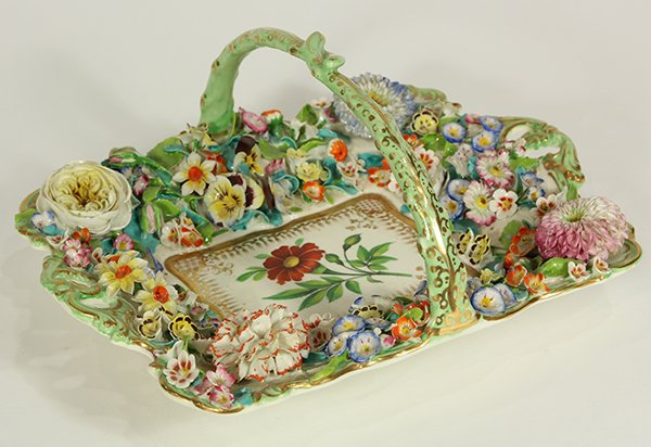 English porcelain flower encrusted dessert basket: English porcelain flower encrusted dessert basket, circa 1830, possibly Minton or Coalbrookdale, having a partial gilt handle continuing to the applied floral border flanking the polychrome decorated 