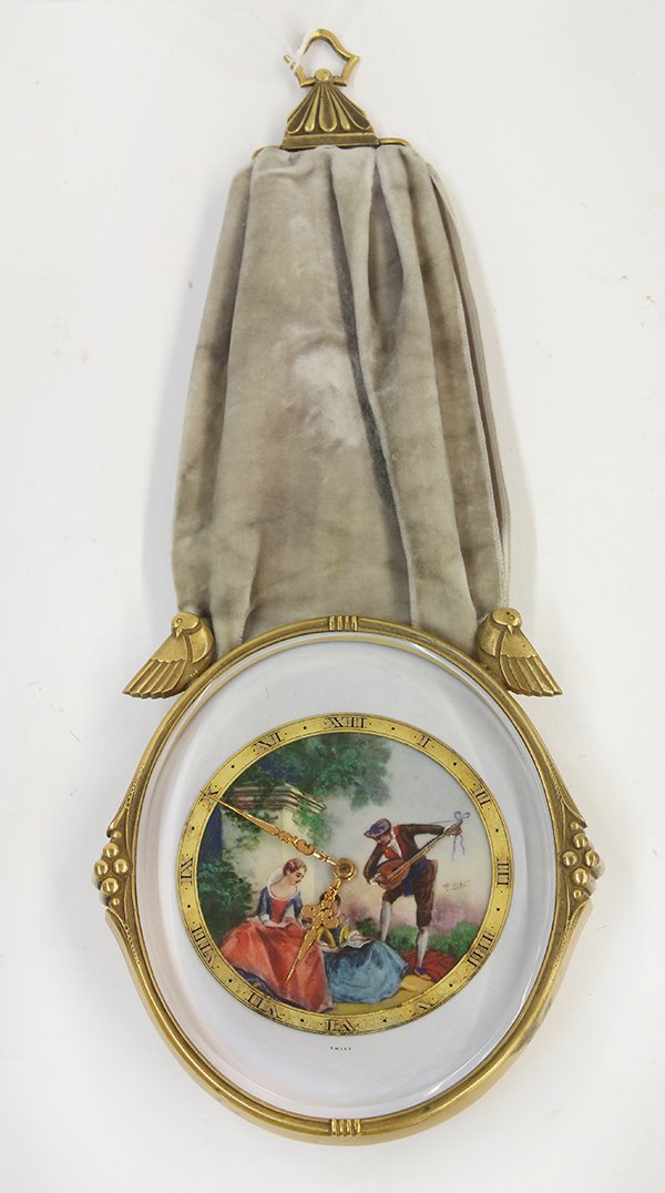 Bittmann St: Bittmann St. Moritz wall clock, having a velvet support suspending the circular case, the dial depicting a Classical scene, 11"h x 4.5"w Provenance: From the Pebble Beach, CA estate of Richard Mellon