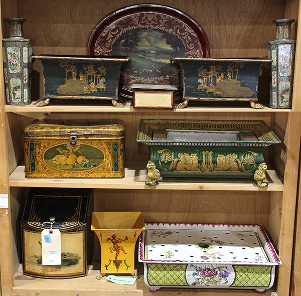 (lot of 10) Three shelves of tole decoratives,: (lot of 10) Three shelves of tole decoratives, including a pair of Regency style jardineres with Chinoiserie decoration on black grounds, each rising on gilt paw feet, 19th century; a tin box painted