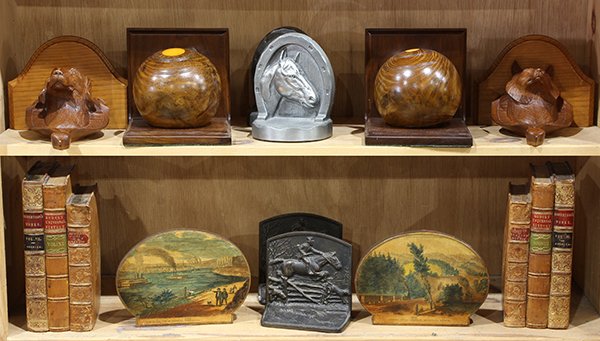 (lot of 12) English and English style figural bookends: (lot of 12) English and English style figural bookends including a pair of mahogany lawn balls, fashioned into bookends; together with a pair of leather bound book ends, and hound and fox carved wall 