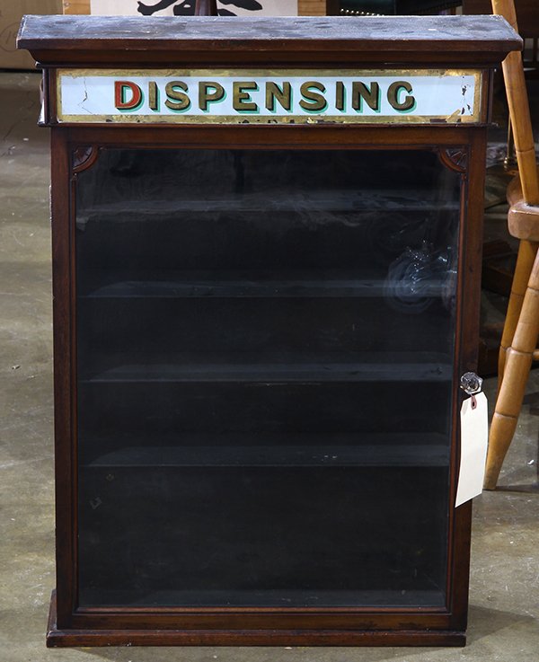 Apothecary "Dispensing" display cabinet, executed in: Apothecary "Dispensing" display cabinet, executed in mahogany with a glazed door opening to a fitted interior, retains sign reading "Dispensing", 30"h x 23"w x 7"d. Provenance: From the Ligonier, PA e