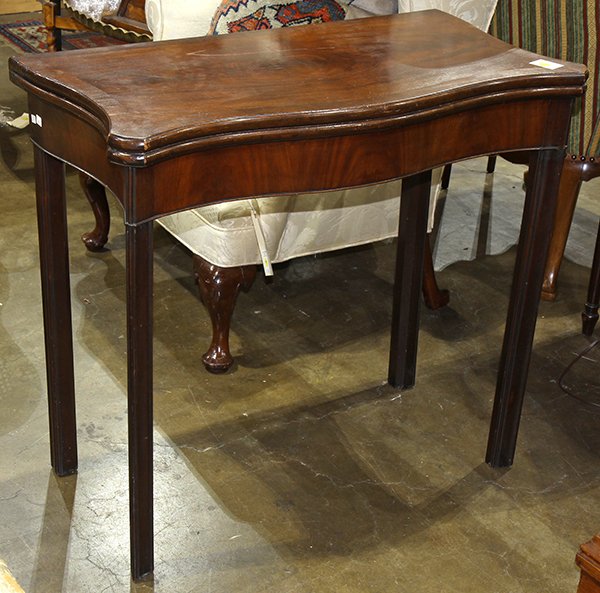 Regency style flip top games table, executed in walnut,: Regency style flip top games table, executed in walnut, having a serpentine top opening to the later leather top, and rising on chamfered legs, 30"h x 33"w x 17"d. Provenance: Property from the coll