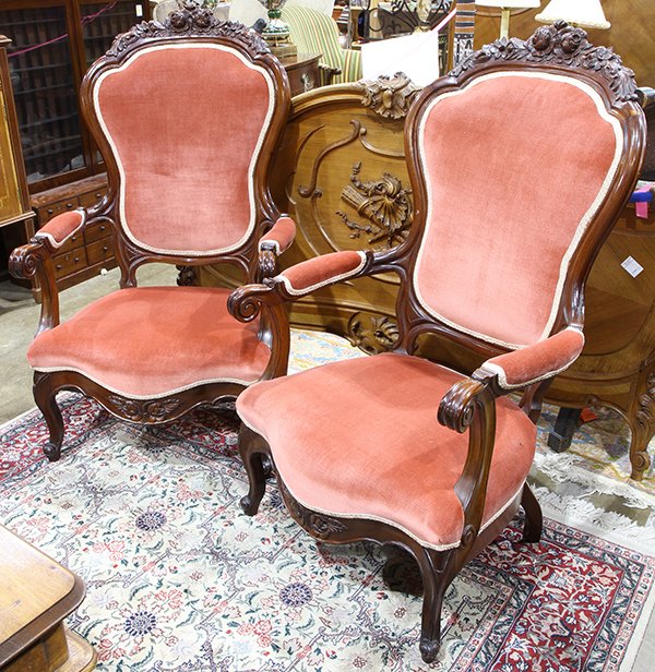 Pair of Victorian style fireside chairs, each having a: Pair of Victorian style fireside chairs, each having a floral carved crest surmounting the shield form back, and rising on cabriole legs, 45"h x 27"w x 22"d. Provenance: Property from the collection