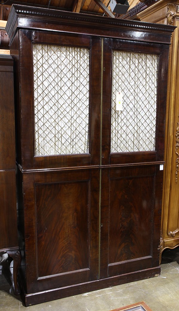English Regency style linen press: English Regency style linen press, the two door case with flame mahogany panels, opening to the fixes shelves, and rising on a molded base, 81"h x 47"w x 24"d