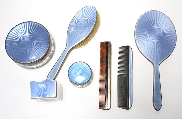 (lot of 7) American hand wrought sterling silver: (lot of 7) American hand wrought sterling silver mounted blue guilloche enamel and sterling silver vanity accessories, comprising a comb, a brush,a mirror, a square glass box with silver and enamel li