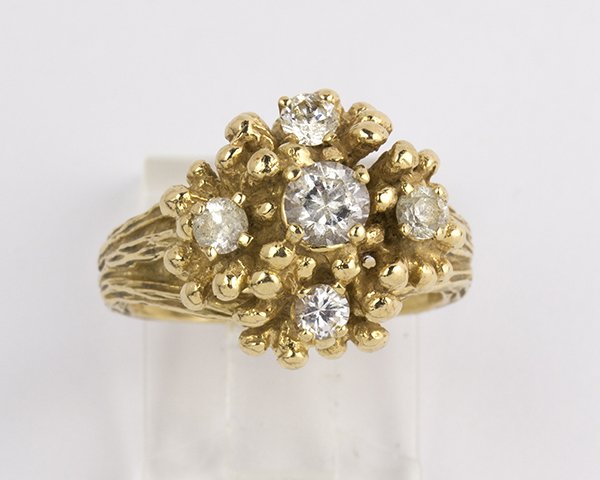 Zircon and 14k yellow gold ring: Zircon and 14k yellow gold ring set with (5) round cut colorless zircons set in a 14k yellow gold mounting, size 6, weighs 10.9 grams Note: one stone is chipped, others are abraded