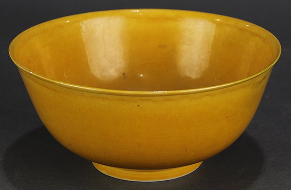 Chinese Yellow Porcelain Bowl: Chinese yellow glazed porcelain bowl, with a slightly flared rim and a deep body, the recessed base with an underglaze blue Guangxu mark, 5.75"w; Provenance: Estate of Dr. Graeme Hanson, San Francisco