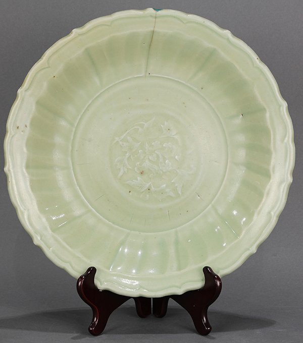 Chinese Celadon Charger: Chinese celadon glazed ceramic charger, Ming Dynasty (14th/15th century), the well molded with a leafy sprig, the wall in the form of flower petals and with a foliate rim (hairline crack), 13.125"w; P