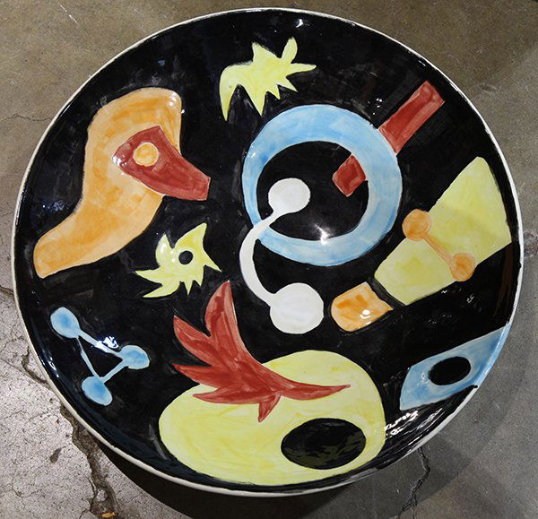 Brad Howe (American: Brad Howe (American, b.1959) pottery center bowl, the interior having polychrome decoration with stylized figures on a black ground, signed and dated '99, 20.5"dia.
