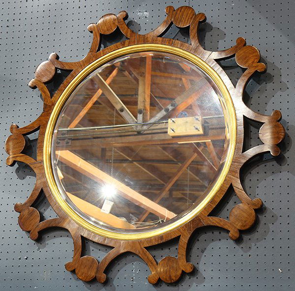 North European walnut mirror: North European walnut mirror, second quarter 19th century, probably German or Austrian, having a pierced decorated rim, continuing to a gilt border, centering the circular looking glass, 42"dia. Prove