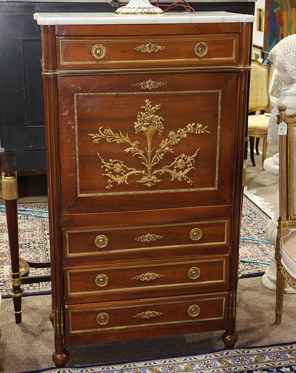 Louis XVI style secretaire a abattant, executed in: Louis XVI style secretaire a abattant, executed in mahogany, having a shaped marble top, surmounting a single drawer having gilt escutcheons, above the fall front centered with an ormolu floral bouque