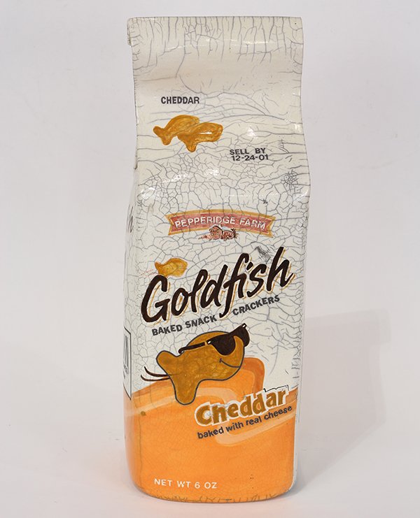 Sculpture by Karen Shapiro: Karen Shapiro (American, b. 1947), Giant Goldfish Cracker Bag, ceramic sculpture, stamped "K" on bottom, overall: 18.25"h x 6.5"w x 5.5"d.