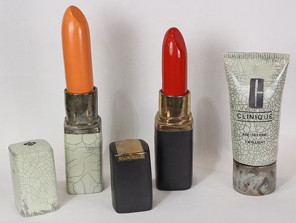 Sculptures by Karen Shapiro: (lot of 5) Karen Shapiro (American, b. 1947), Giant Lipsticks and Clinique Emollient, ceramic sculptures, stamped "K" on bottom, largest overall: 20.5"h x 4"w x 4"d.