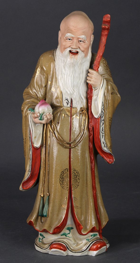 Chinese Porcelain Shoulao, Wang Quan Ji: Chinese enameled porcelain figure of Shoulao, the elder in a gilt tan colored robe, holding a staff and peach, the base sealed 'Wang Quan ji zao', 16"h