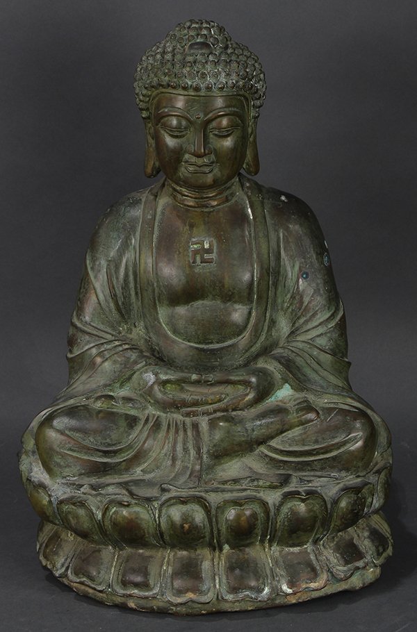 Japanese Metal Seated Buddha: Japanese metal Amida Nyorai Buddha, seated on a lotus dais with hands in dhyanamudra (mudra of concentration) position, a manji (Buddhist tetra-gammadion) mark on the chest, approx. 19.5"h x 13"w x 11