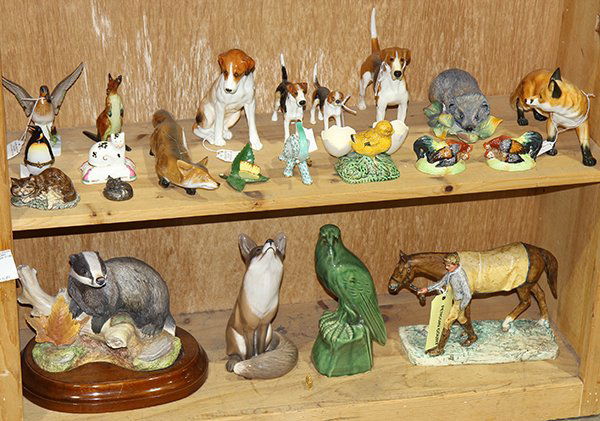 Two shelves of associated animal figurines, executed in (1 of 2)