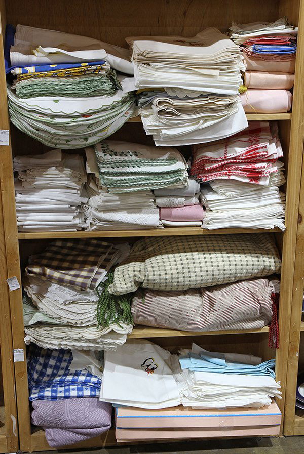 Four shelves of assorted table and bed linens (1 of 1)