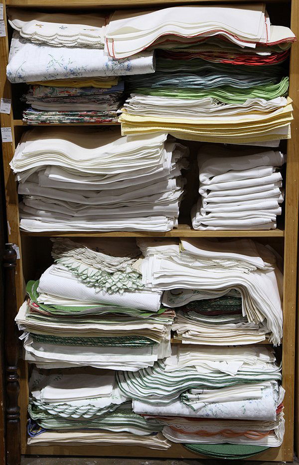 Four shelves of  table and bed linens (1 of 2)