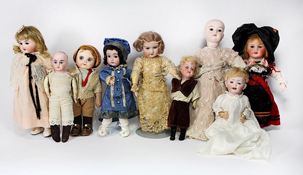 (lot of 9) Diminutive French and German Bisque dolls,: (lot of 9) Diminutive French and German Bisque dolls, including a male doll with moving blue googly eyes, on a cloth body, dressed in short pants and a sweater, 10"h, a Unis France #301 doll having a 