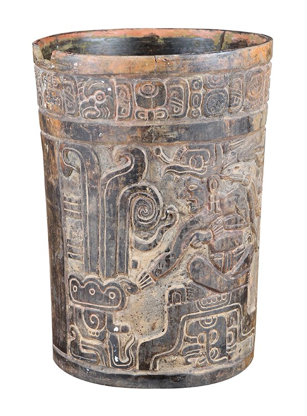 Pre-Columbian Mayan clay cylinder vessel, classical: Pre-Columbian Mayan clay cylinder vessel, classical period 600-900 AD, the exterior having carved and incised decoration, with a band of glyghs near the rim, above two panels depicting a seated lord o