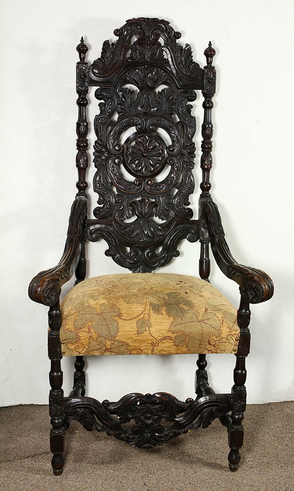 Italian carved oak hall chair, circa 1860, the high: Italian carved oak hall chair, circa 1860, the high pierce carved back centered with a floral medallion flanked with floral and scroll decorated sprays, continuing to the padded seat flanked with outs
