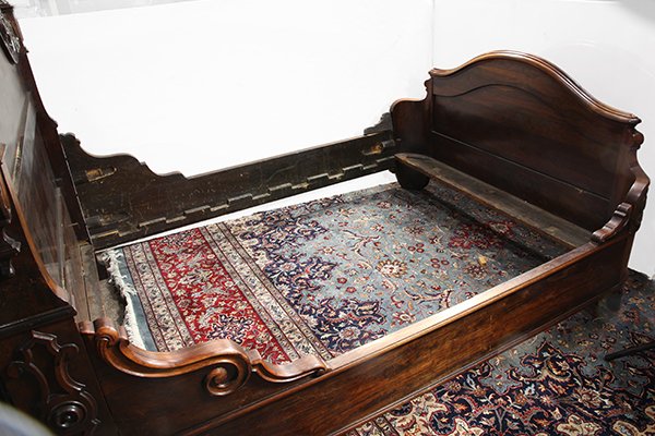 American Rococo Revival bed stead, circa 1860, executed: American Rococo Revival bed stead, circa 1860, executed in rosewood, the curved and molded crest above a high relief carved fruit trophy with swags flanked by urn form acanthus finials rising on colum