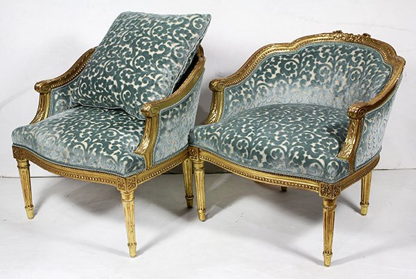 Pair of diminutive Northern European giltwood bergeres: Pair of diminutive Northern European giltwood bergeres, each having a ribbon carved crest, above the blue upholstered seat and back, and rising on fluted legs, accented with rosette medallions, 25"h x