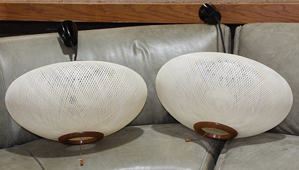 (Lot of 2) Japanese Mid-Century Modern hanging light: (Lot of 2) Japanese Mid-Century Modern hanging light fixtures, each having a squat circular form with a cream shade, above a wood frame, 9.5"h