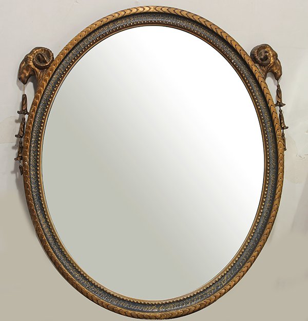 Neoclassical style gilt and polychrome decorated wall: Neoclassical style gilt and polychrome decorated wall mirror, having rams head mounts surmounting the bellflower accents, 32"h x 28"w Provenance: From the Ligonier, PA estate of Richard Mellon Scaife
