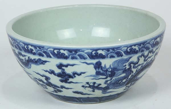 Chinese Blue and White Bowl, Dragons: Chinese underglaze blue porcelain bowl, with two meandering dragons depicted under a wave band below the rim and above a lappet band, interior with an apocryphal Xuande mark, 10.6"w
