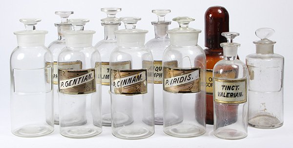 (lot of 10) Apothecary jar group, having ground: (lot of 10) Apothecary jar group, having ground stoppers, most with enamel and gilt labels, including one amber example, tallest 10.25"h. Provenance: Property from the collection of Trotter’s Antiqu