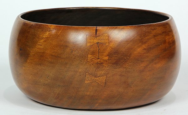 Hawaiian koa wood poi bowl: Hawaiian koa wood poi bowl (calabash), 19th century, having a circular hollowed form with several indigenous repairs including butterfly mends, 4.75"h x 9.5"w