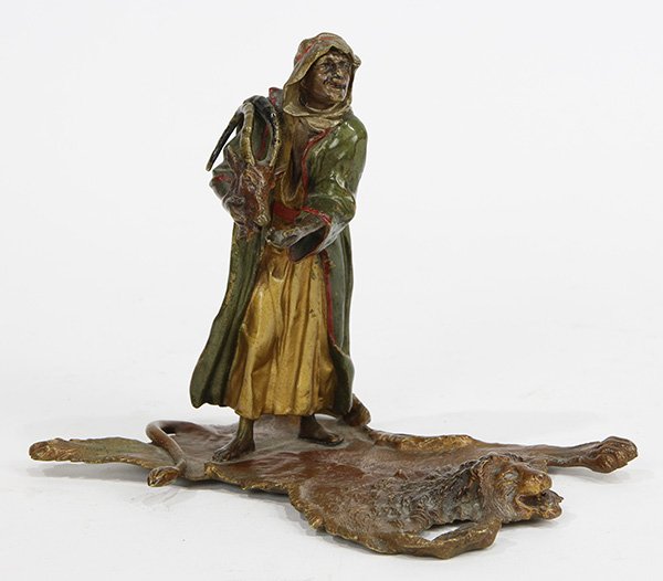 Franz Bergmann (Austrian 1898-1963) Orientalist cold: Franz Bergmann (Austrian 1898-1963) Orientalist cold painted bronze, entitled "Bedouin Trade," depicting an Arab trader standing on a tiger skin rug offering an antelope skull, artist stamped lower ve