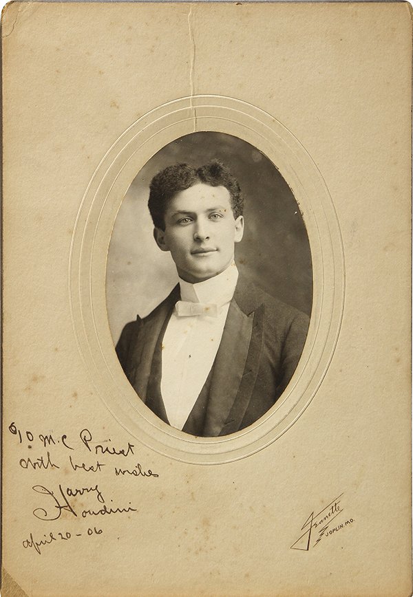 Harry Houdini signed photograph: Harry Houdini signed photograph, 1906, the oval portrait showing a young Houdini is inscribed, 'To MC Priest/ With best wishes/ Harry Houdini/ April 20, 1906, printed on card stock bearing the inscrip