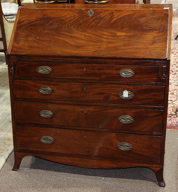Federal Hepplewhite slant front desk: Federal Hepplewhite slant front desk, circa 1815, executed in figured mahogany, the fall front opening to a fitted interior with hidden cabinets, the lower case with four drawers, and rising on French