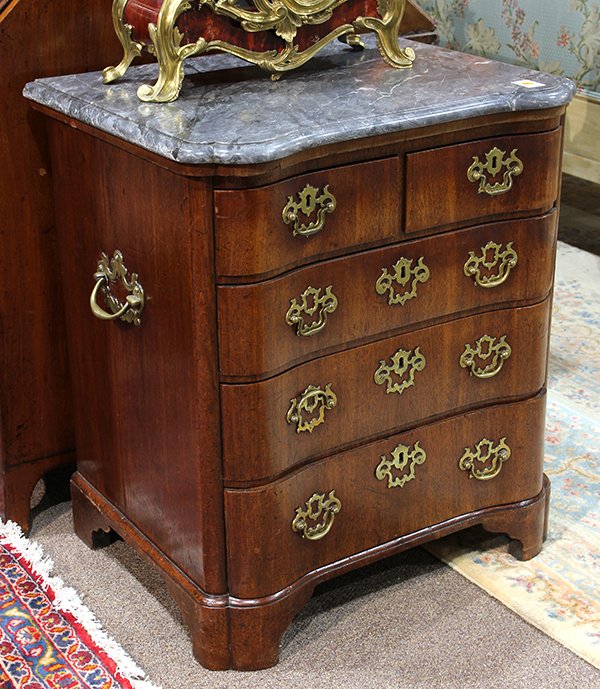 North European walnut four drawer commode: North European walnut four drawer commode, early 19th century, having a shaped marble top (repaired), above the five drawer case, and rising on bracket feet, 31.5"h x 27.5"w x 21"d Provenance: From th