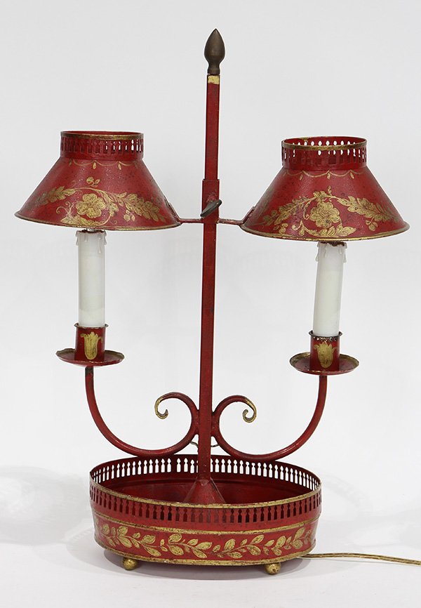French tole decorated bouillotte lamp: French tole decorated bouillotte lamp, having two lights, the adjustable shades decorated with gilt acanthus leaves on a red ground, and terminating on an oval reticulated and footed base, 20"h