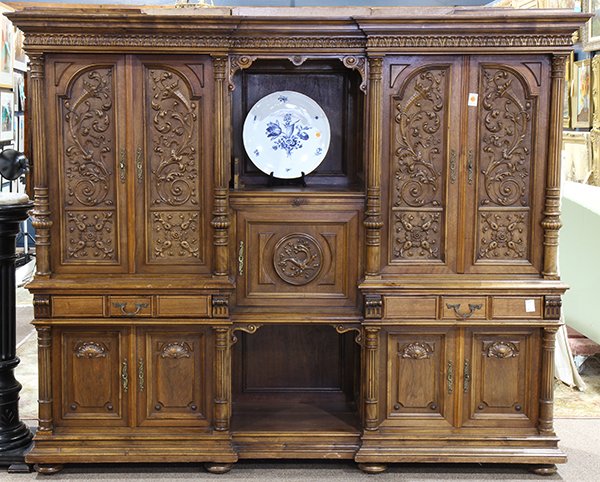 Continental Renaissance style ornately carved walnut: Continental Renaissance style ornately carved walnut buffet, circa 1890, having a molded cornice, above the case, having four sets of paneled doors, each decorated with ribbons, acanthus, and rosette 